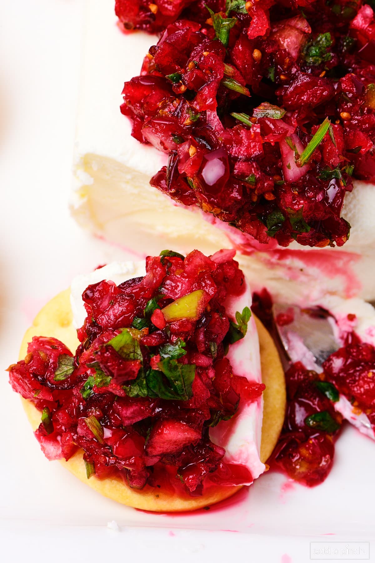 Cranberry Salsa over cream cheese, also scooped onto a round cracker.